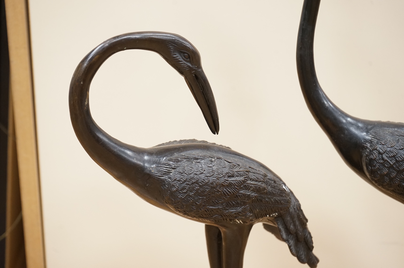 A pair of patinated bronze cranes, 62cm